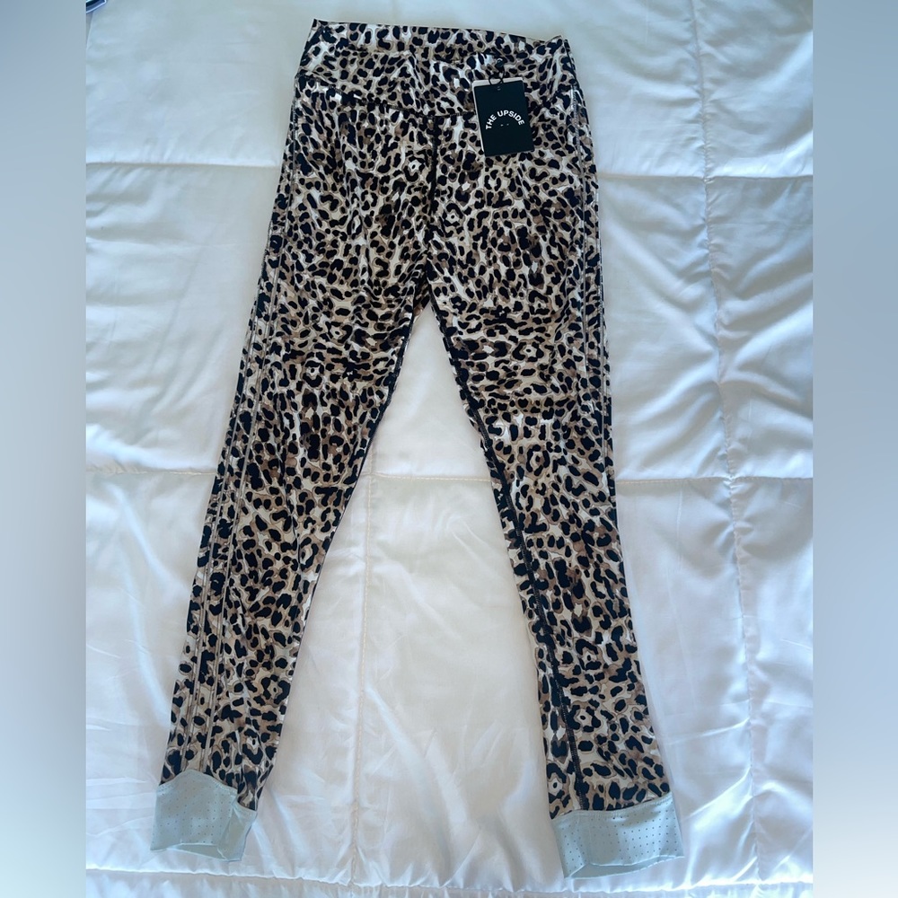 The Upside Cheetah print 3/4 leggings with hem detail in size M.